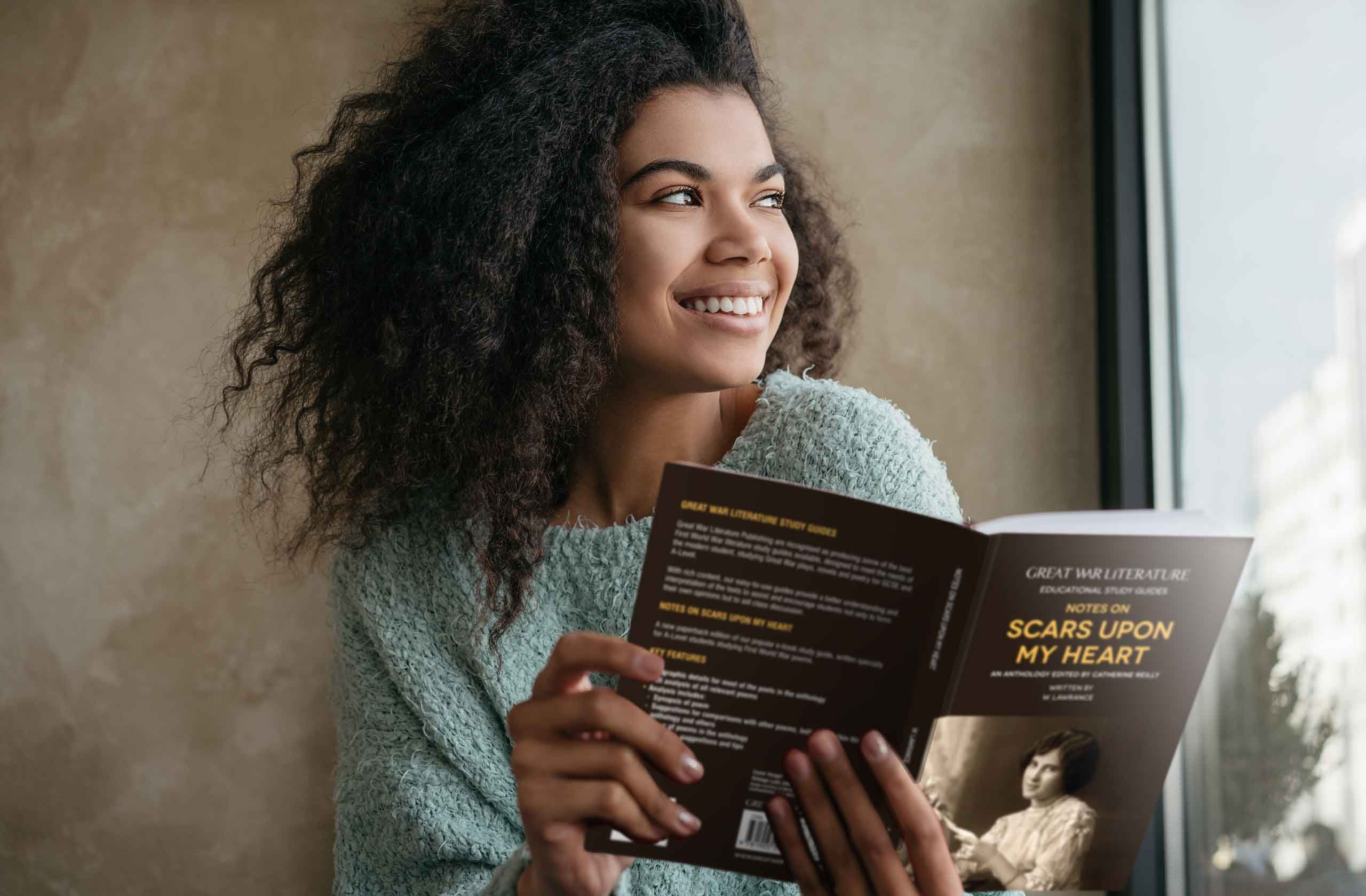 Student reading the study guide on Scars Upon my Heart